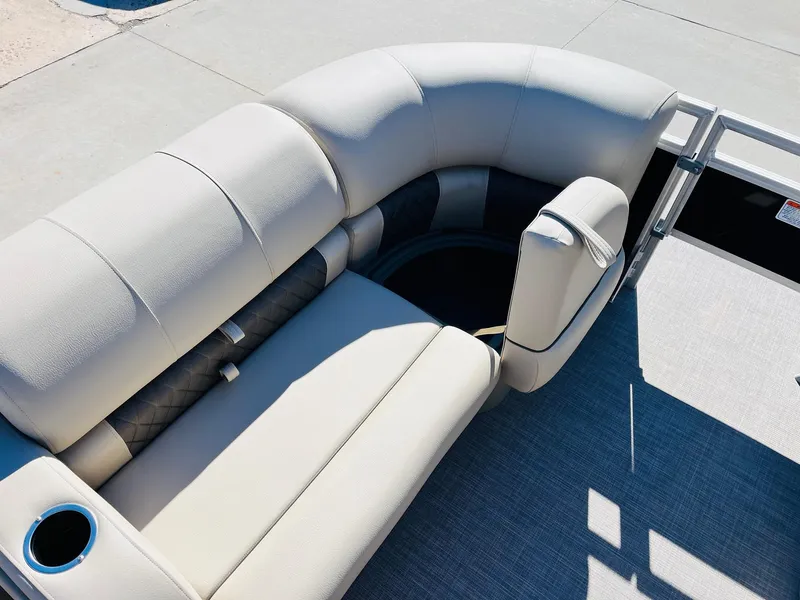 Slide: The Image of 2025 Sun Tracker SportFish 22 XP3 boat interior with beige seating and cup holder. - 18