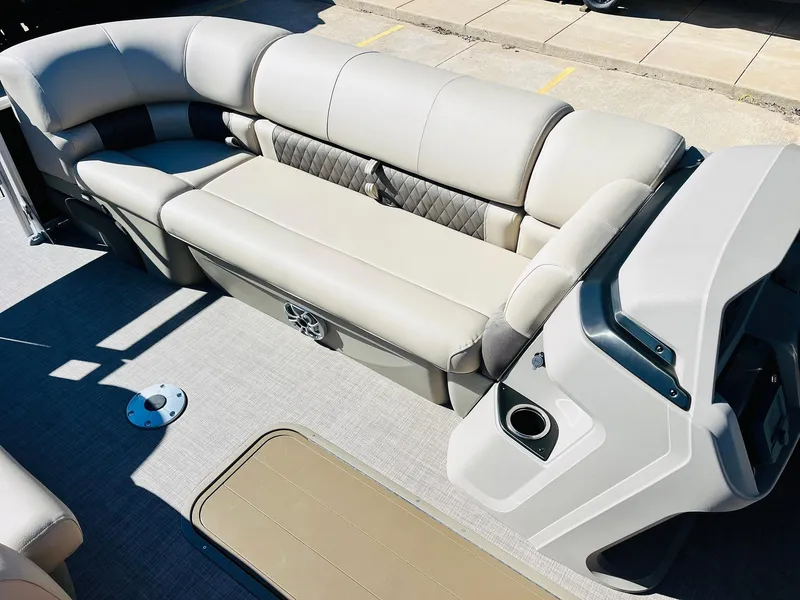 Slide: The Image of 2025 Sun Tracker SportFish 22 XP3 boat interior with beige seating and console. - 21