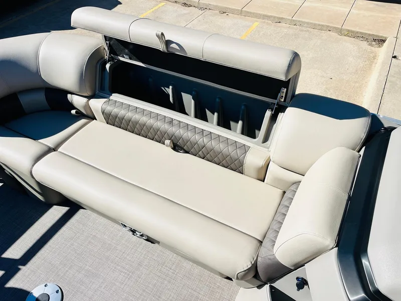 Slide: The Image of Sun Tracker SportFish 22 XP3 2025 boat seating with storage compartment, beige upholstery. - 22