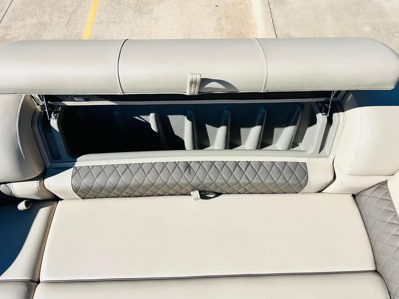 Slide: The Image of 2025 Sun Tracker SportFish 22 XP3 boat seat with storage compartment open. - 23