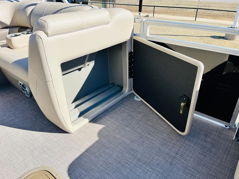 Slide: The Image of 2025 Sun Tracker SportFish 22 XP3 storage compartment with open door on boat deck. - 29
