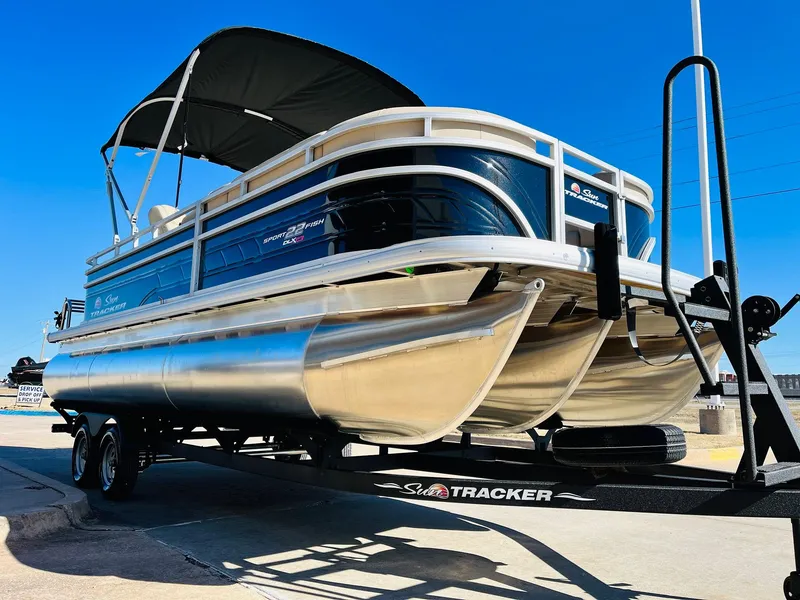 Slide: The Image of 2025 Sun Tracker SportFish 22 XP3 pontoon boat on trailer, sunny day. - 3