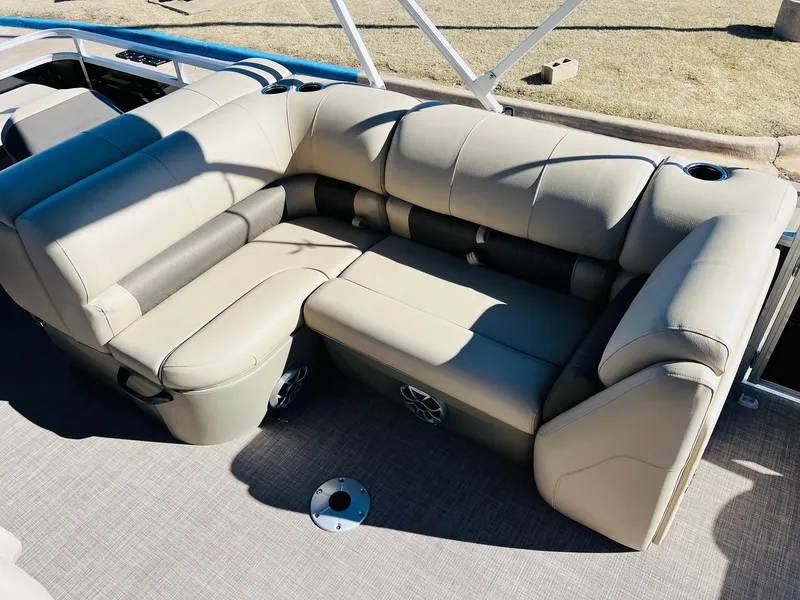 Slide: The Image of 2025 Sun Tracker SportFish 22 XP3 boat with beige seating and cup holders. - 34