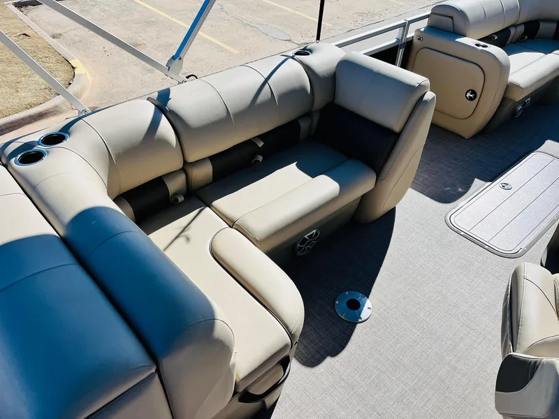 Slide: The Image of 2025 Sun Tracker SportFish 22 XP3 boat interior with beige seating and cup holders. - 35