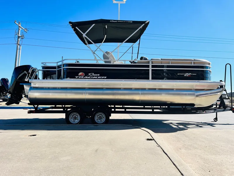 Slide: The Image of 2025 Sun Tracker SportFish 22 XP3 pontoon boat on trailer, side view. - 4