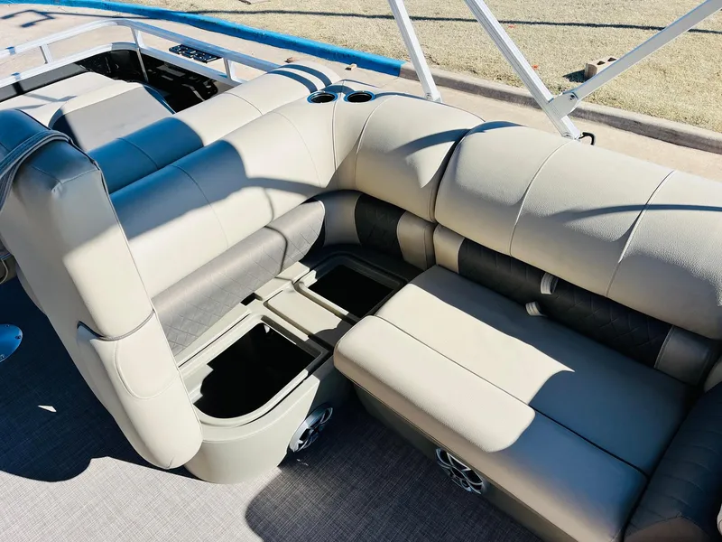 Slide: The Image of 2025 Sun Tracker SportFish 22 XP3 boat interior with beige seating and storage compartments. - 41