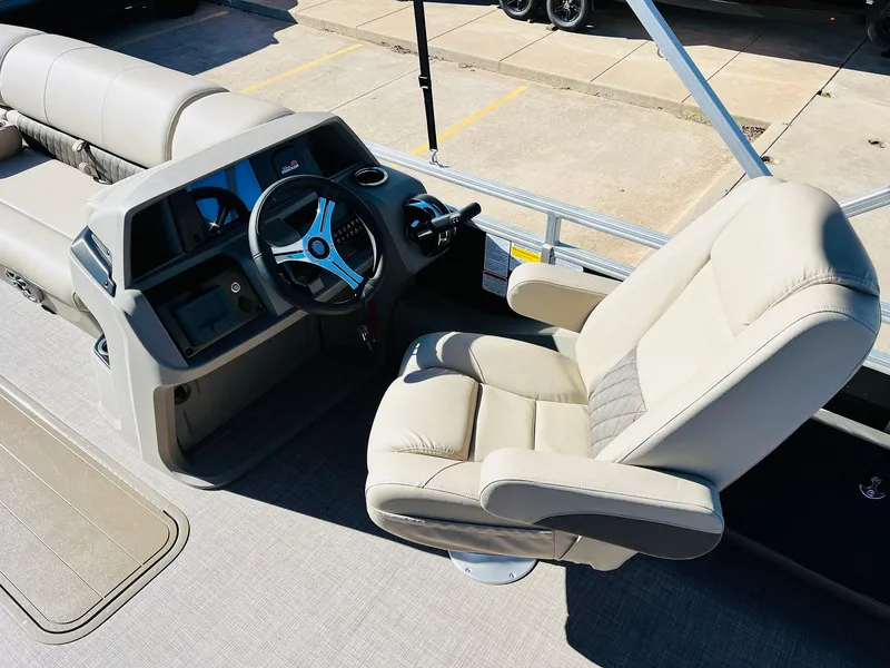 Slide: The Image of 2025 Sun Tracker SportFish 22 XP3 boat interior with steering wheel and captain's chair. - 43