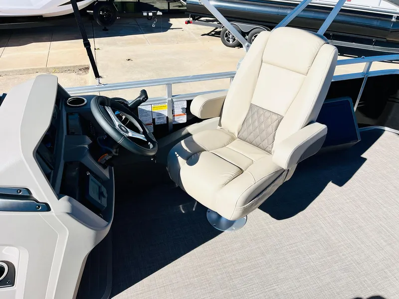 Slide: The Image of 2025 Sun Tracker SportFish 22 XP3 boat interior with captain's chair and steering console. - 44