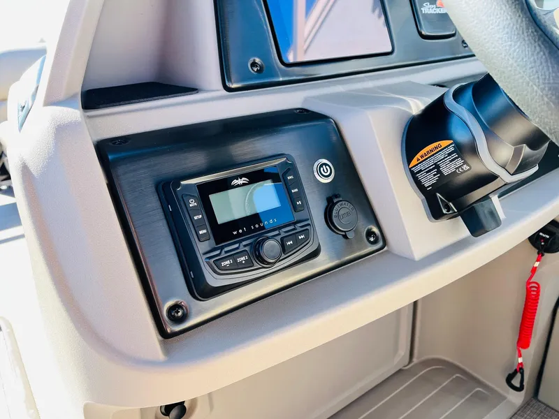 Slide: The Image of Dashboard of 2025 Sun Tracker SportFish 22 XP3 with modern controls and steering wheel. - 45