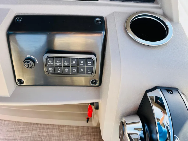 Slide: The Image of Control panel of 2025 Sun Tracker SportFish 22 XP3 boat with cup holder. - 47