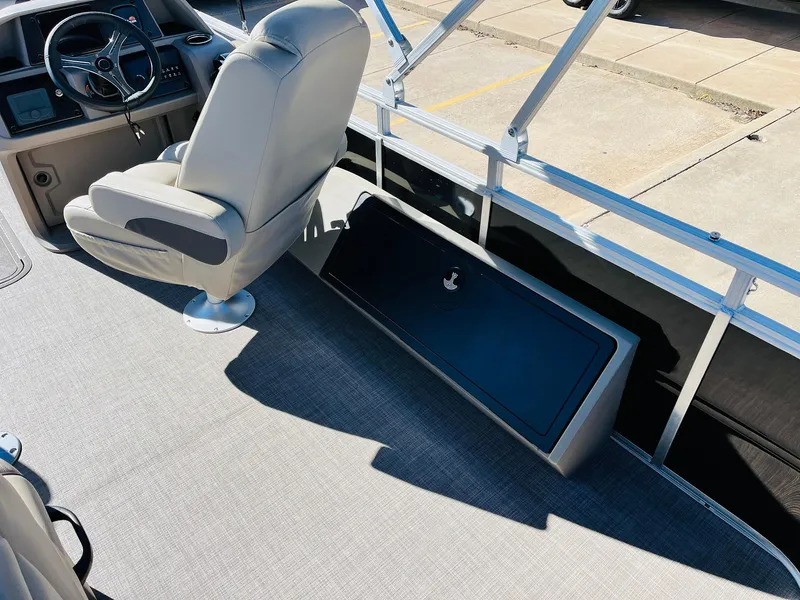 Slide: The Image of 2025 Sun Tracker SportFish 22 XP3 interior with captain's chair and storage compartment. - 48