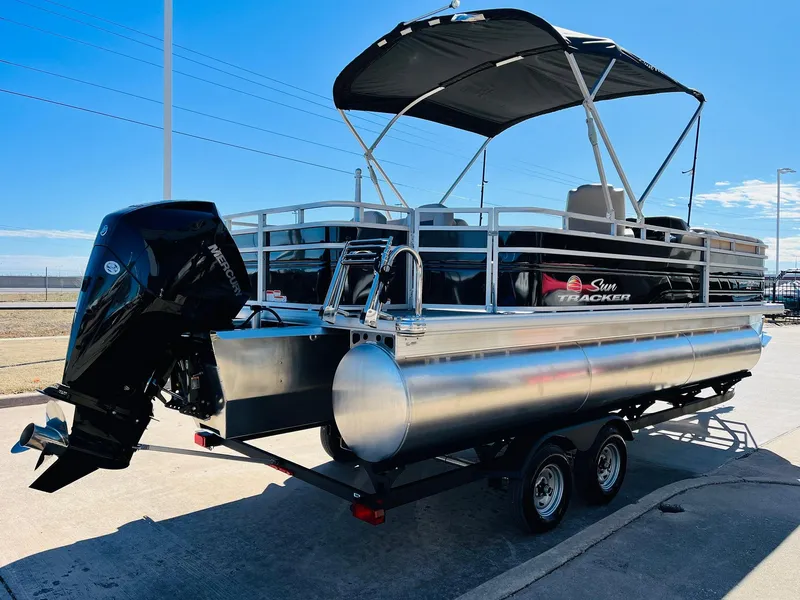 Slide: The Image of 2025 Sun Tracker SportFish 22 XP3 pontoon boat with canopy and outboard motor. - 5