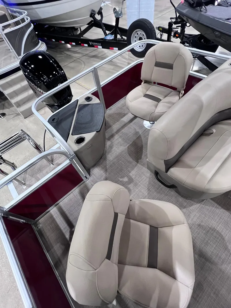 Slide: The Image of 2025 Sun Tracker Bass Buggy 18 DLX interior with beige seating and modern design. - 3