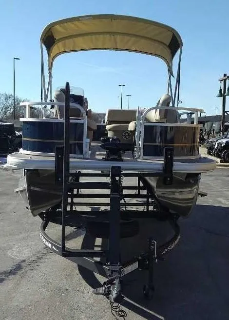 Slide: The Image of 2025 Sun Tracker Bass Buggy 16 XL Select pontoon boat on trailer. - 2