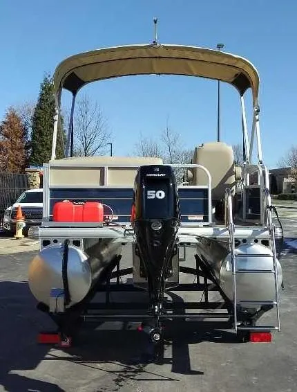 Slide: The Image of 2025 Sun Tracker Bass Buggy 16 XL Select pontoon boat with canopy and outboard motor. - 4