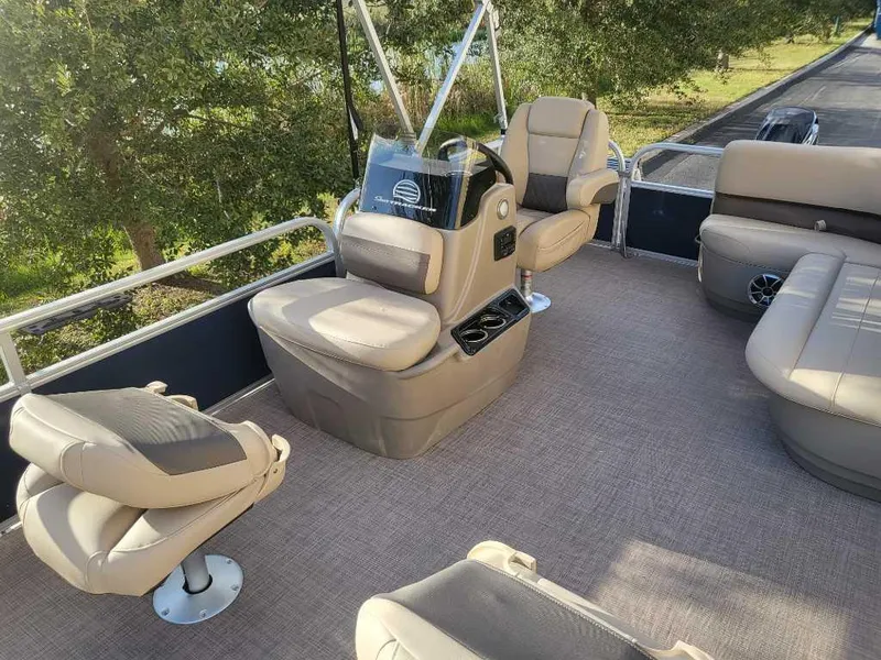 Slide: The Image of 2025 Sun Tracker Bass Buggy 16 XL Select pontoon boat interior with beige seating. - 3