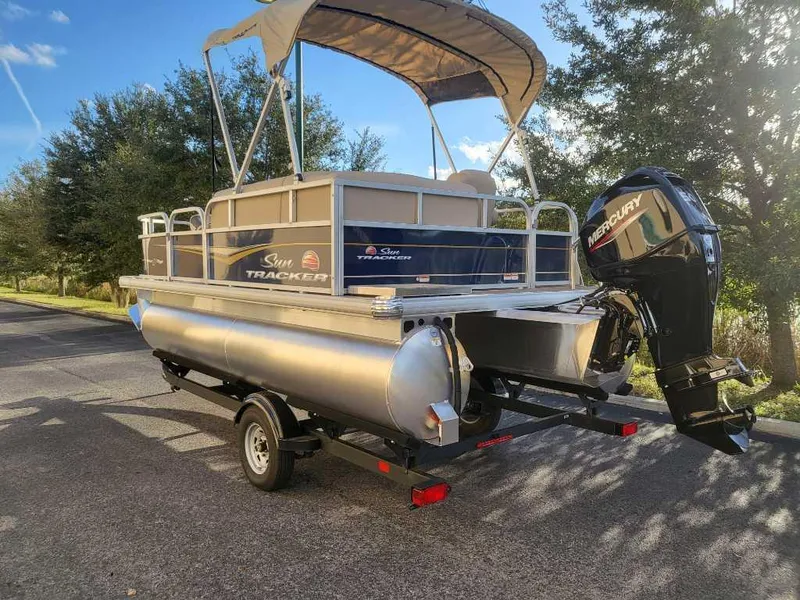 Slide: The Image of 2025 Sun Tracker Bass Buggy 16 XL Select pontoon boat with Mercury outboard motor. - 4
