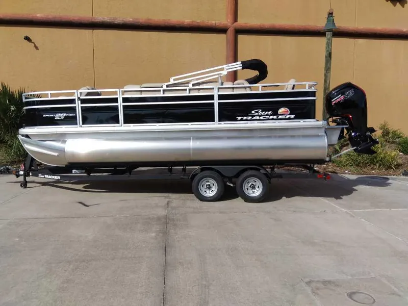The Image of 2025 Sun Tracker SportFish 20 DLX pontoon boat on trailer, side view. - 0