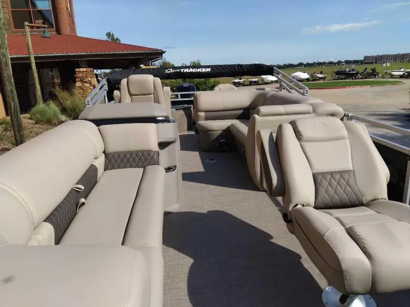 Slide: The Image of 2025 Sun Tracker SportFish 20 DLX pontoon boat with luxurious seating and spacious deck. - 3