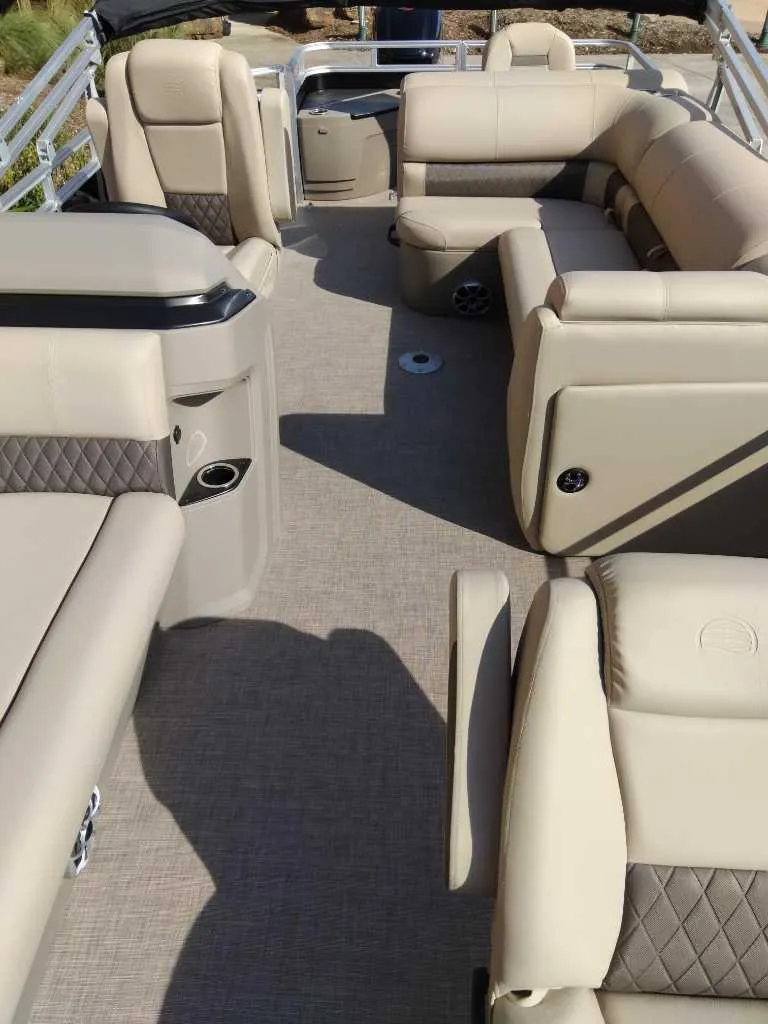 Slide: The Image of 2025 Sun Tracker SportFish 20 DLX interior with beige seating and spacious layout. - 5