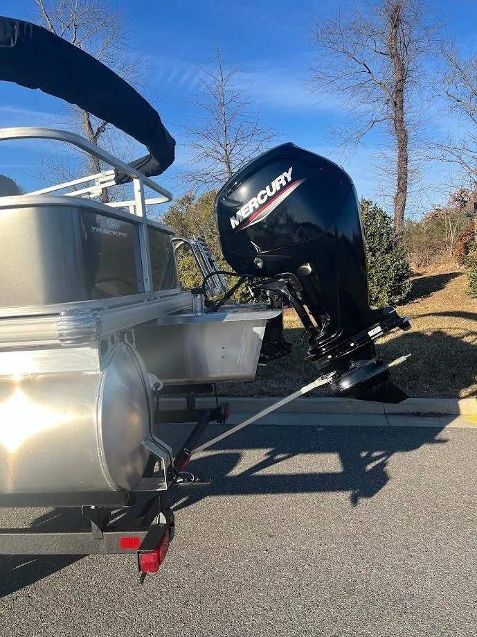 Slide: The Image of 2025 Sun Tracker Party Barge 18 DLX with Mercury outboard motor on a sunny day. - 3