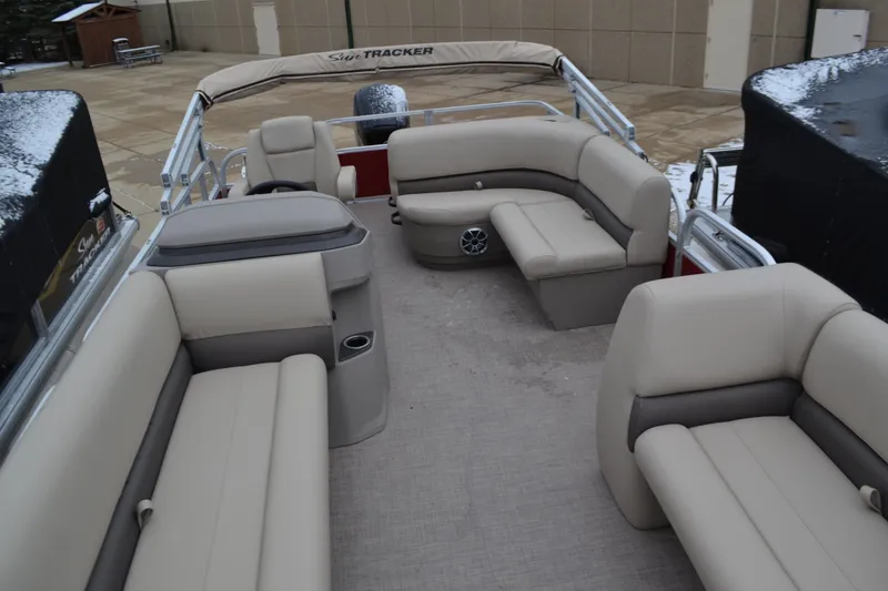 Slide: The Image of 2025 Sun Tracker Party Barge 18 DLX interior with beige seating and spacious layout. - 3