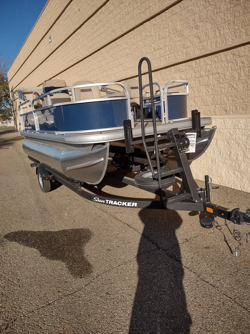 Slide: The Image of 2025 Sun Tracker Bass Buggy 16 XL Select pontoon boat on trailer. - 3
