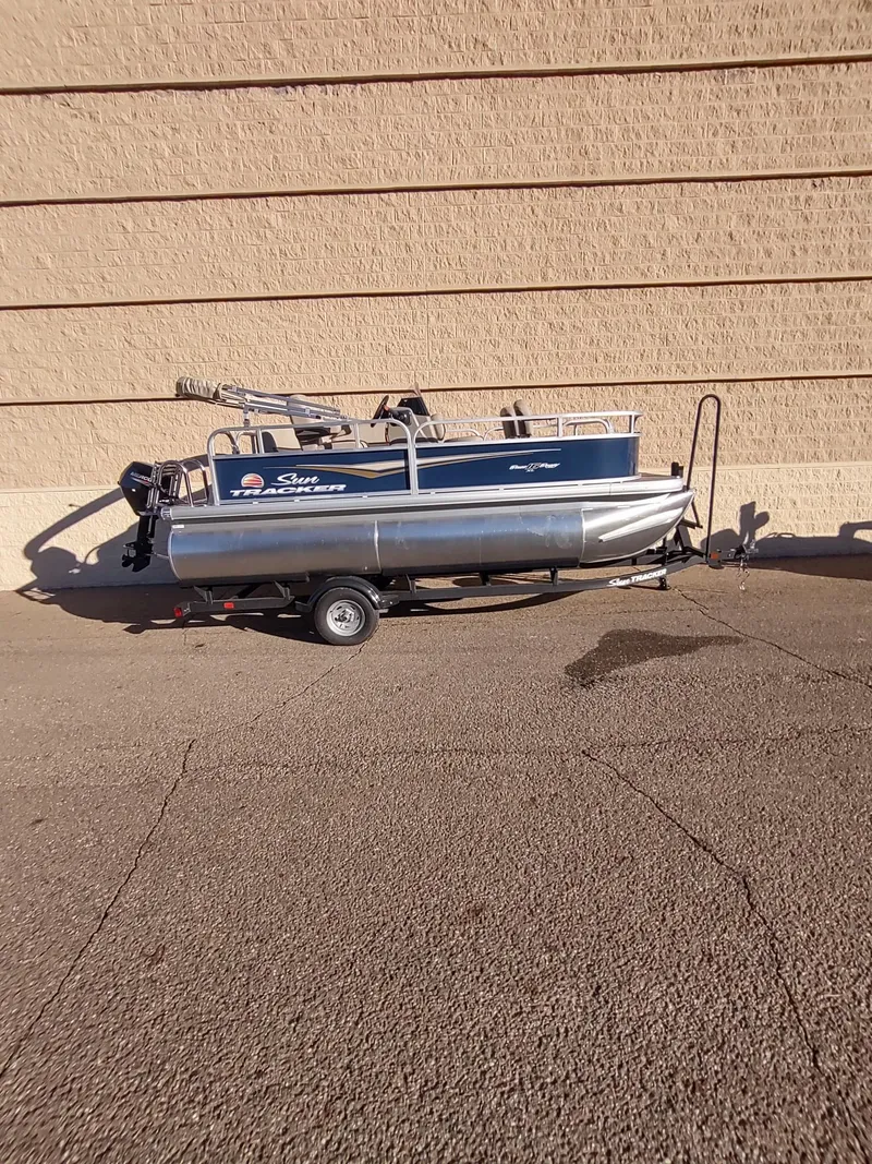 Slide: The Image of 2025 Sun Tracker Bass Buggy 16 XL Select pontoon boat on trailer. - 5