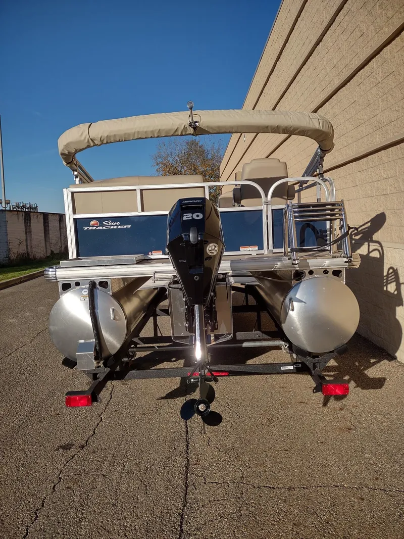 Slide: The Image of 2025 Sun Tracker Bass Buggy 16 XL Select pontoon boat, rear view with motor. - 6
