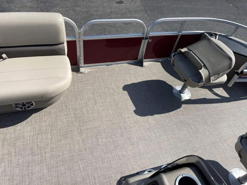 Slide: The Image of 2025 Sun Tracker Bass Buggy 18 DLX pontoon boat interior with seating and cup holders. - 10