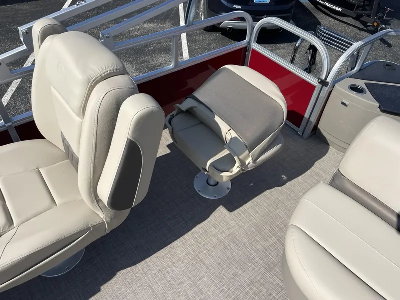 Slide: The Image of 2025 Sun Tracker Bass Buggy 18 DLX interior with beige seating and red accents. - 11