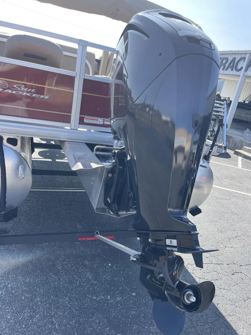 Slide: The Image of 2025 Sun Tracker Bass Buggy 18 DLX pontoon boat with powerful outboard motor. - 2