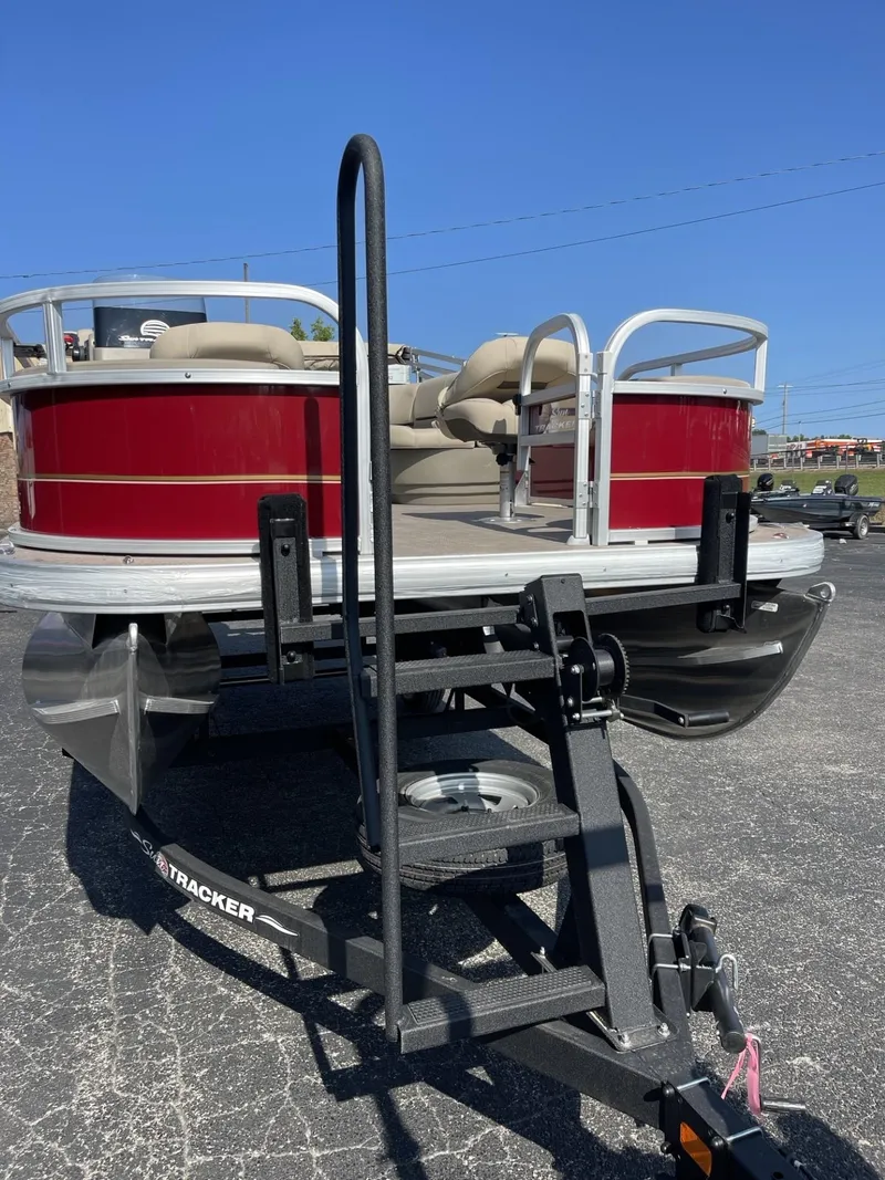 Slide: The Image of 2025 Sun Tracker Bass Buggy 18 DLX pontoon boat on trailer, red and white design. - 4