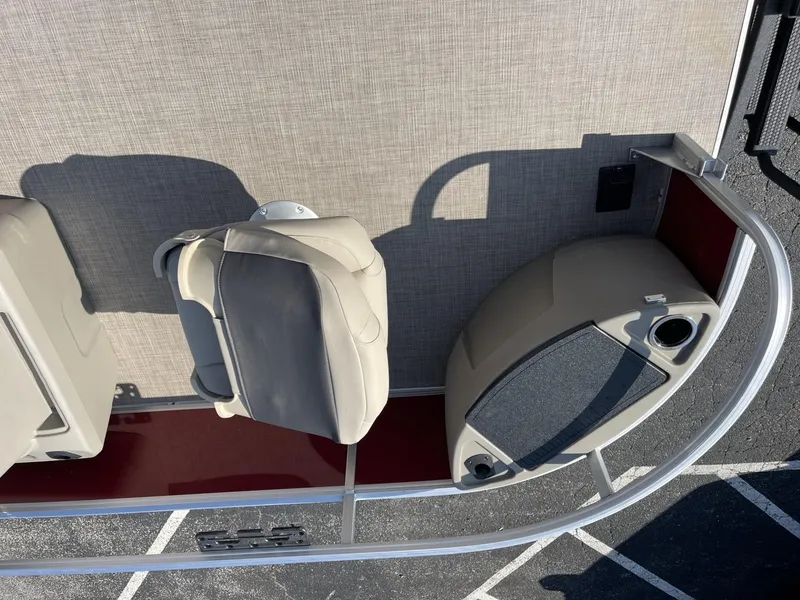 Slide: The Image of 2025 Sun Tracker Bass Buggy 18 DLX boat interior with beige seating and speaker. - 6