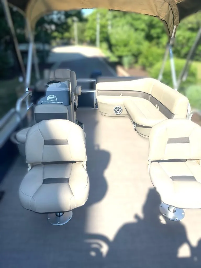 Slide: The Image of 2025 Sun Tracker Bass Buggy 16 XL Select pontoon boat interior with beige seating. - 3