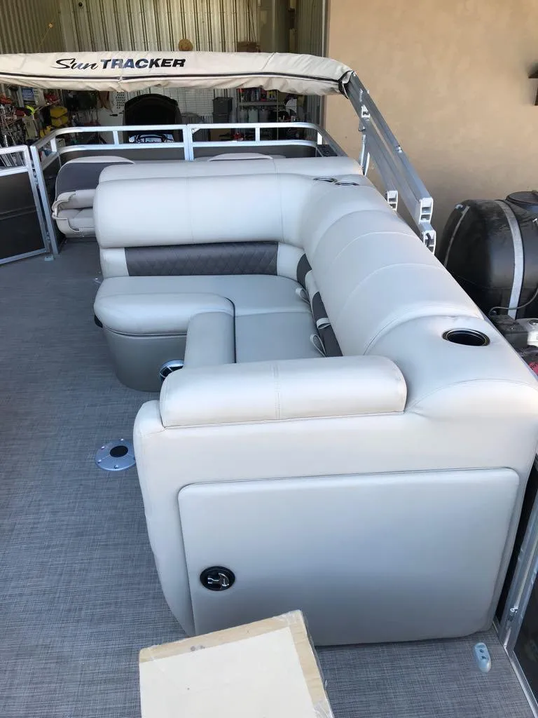 Slide: The Image of 2025 Sun Tracker SportFish 22 DLX pontoon boat with plush seating. - 11