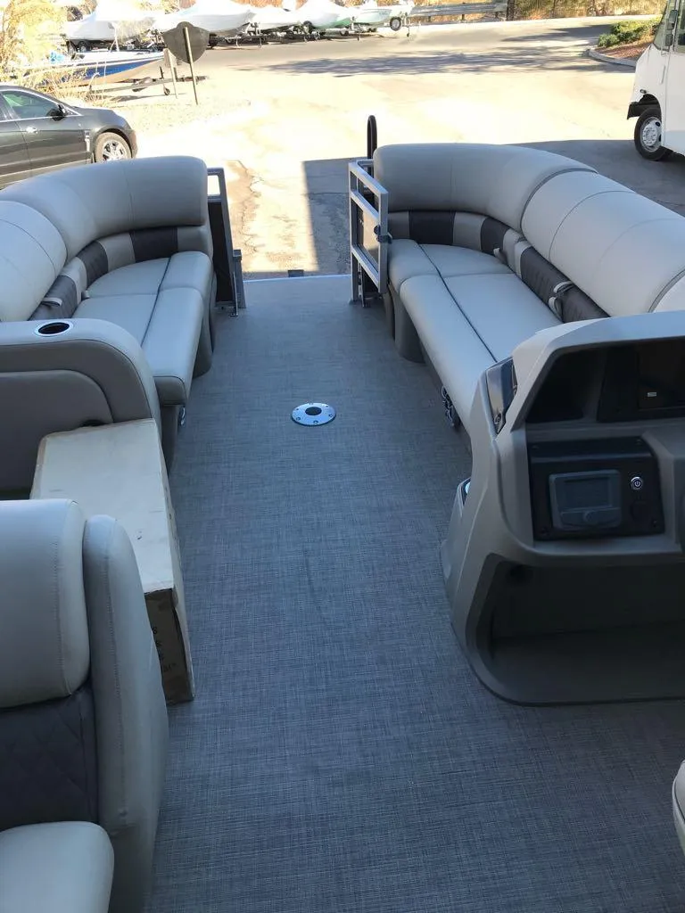 Slide: The Image of 2025 Sun Tracker SportFish 22 DLX pontoon boat interior with spacious seating and modern dashboard. - 13