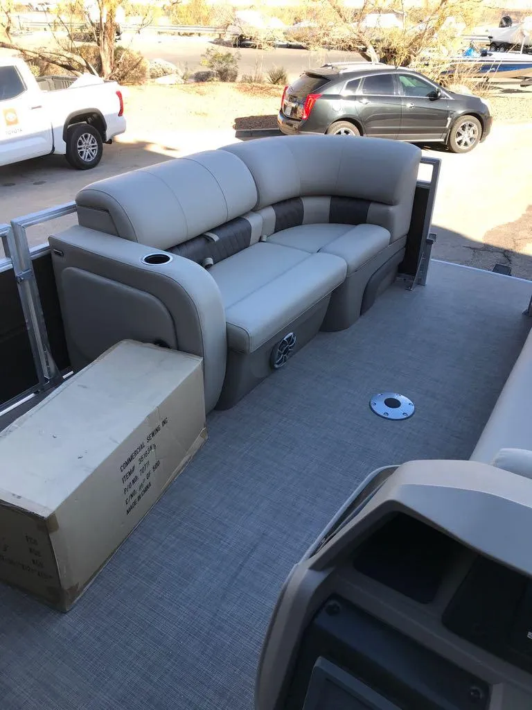 Slide: The Image of 2025 Sun Tracker SportFish 22 DLX pontoon boat interior with plush seating. - 15