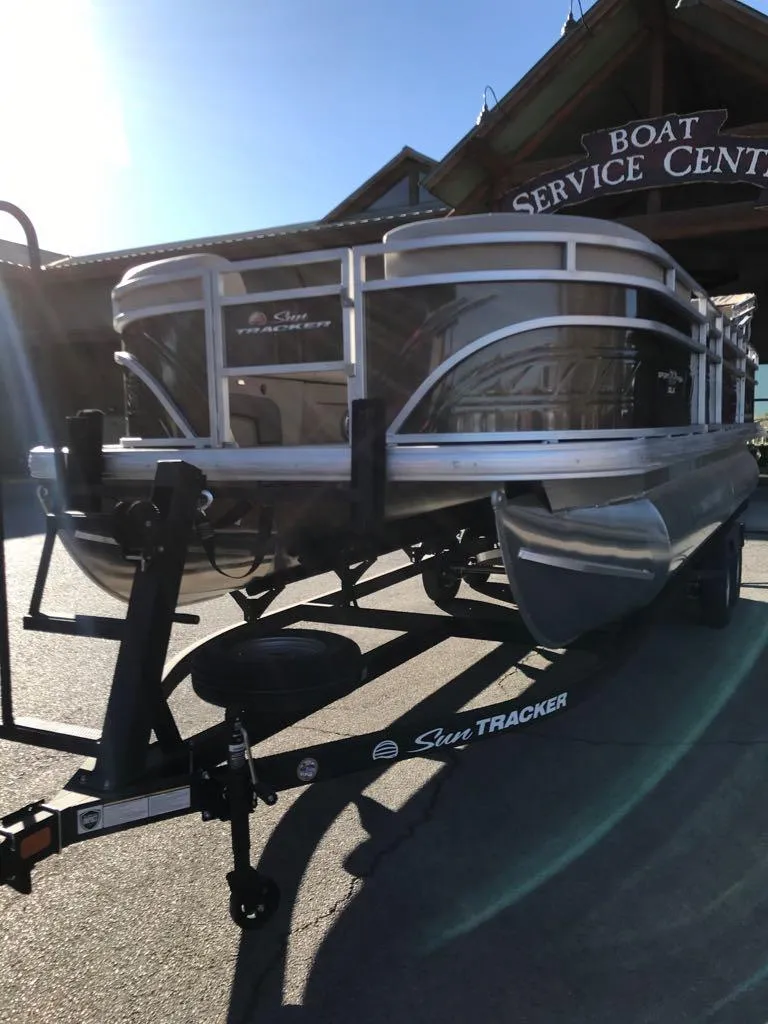 Slide: The Image of 2025 Sun Tracker SportFish 22 DLX pontoon boat at service center. - 2
