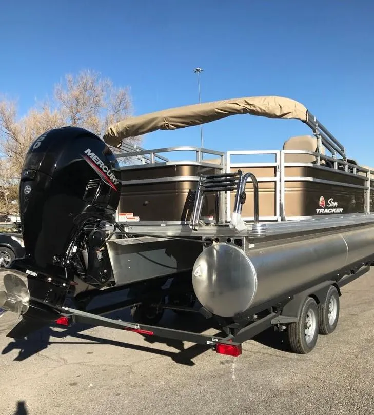 Slide: The Image of 2025 Sun Tracker SportFish 22 DLX pontoon boat with Mercury outboard engine. - 4