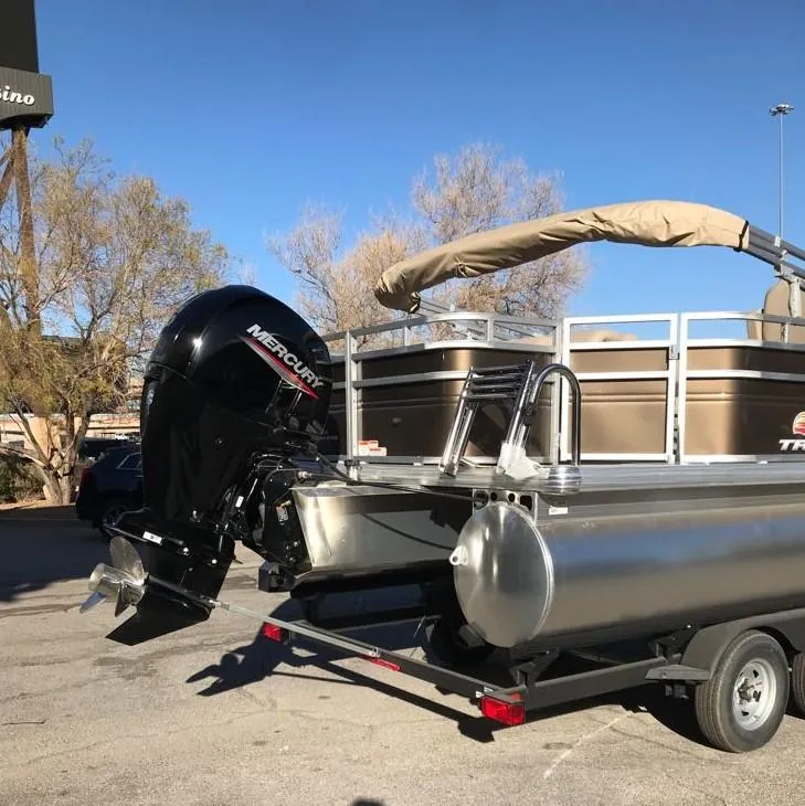 Slide: The Image of 2025 Sun Tracker SportFish 22 DLX pontoon boat with Mercury engine on trailer. - 5