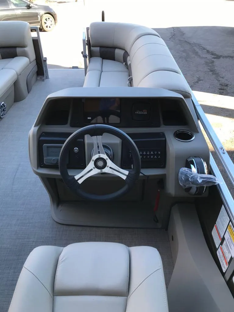 Slide: The Image of 2025 Sun Tracker SportFish 22 DLX boat interior with steering console and seating. - 8