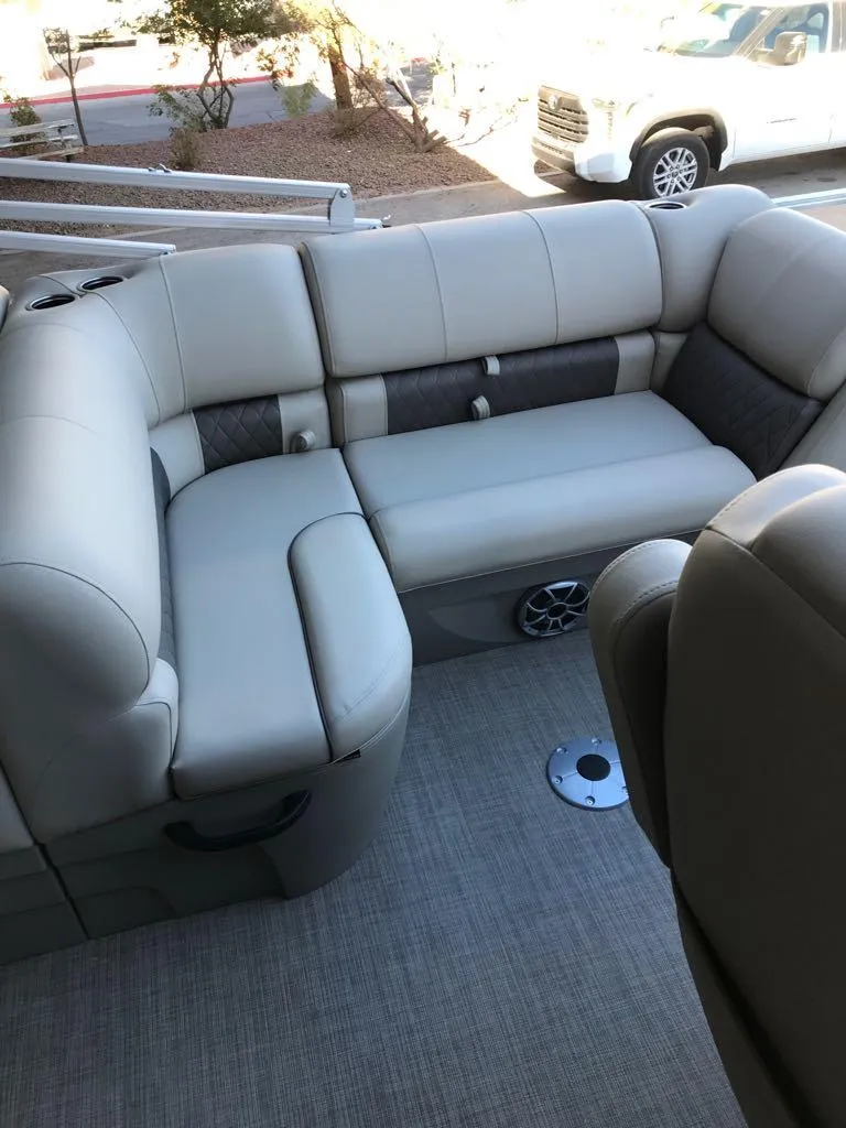 Slide: The Image of 2025 Sun Tracker SportFish 22 DLX boat interior with plush seating and modern design. - 9