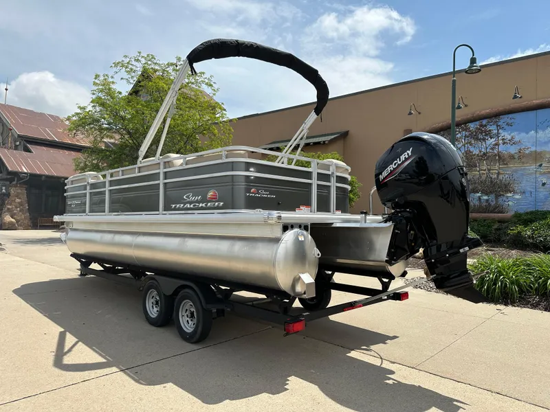 Slide: The Image of 2025 Sun Tracker Party Barge 22 RF DLX pontoon boat with Mercury engine on trailer. - 2