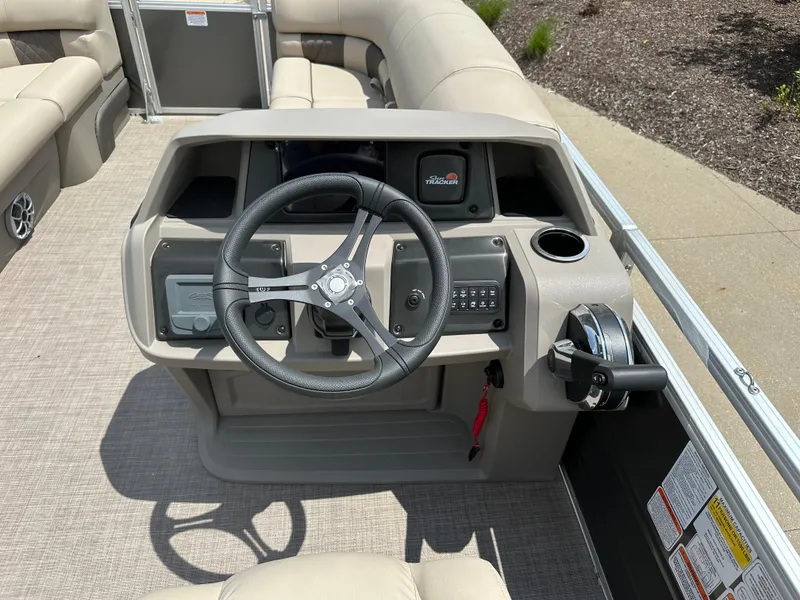 Slide: The Image of 2025 Sun Tracker Party Barge 22 RF DLX steering console with modern controls and seating. - 5