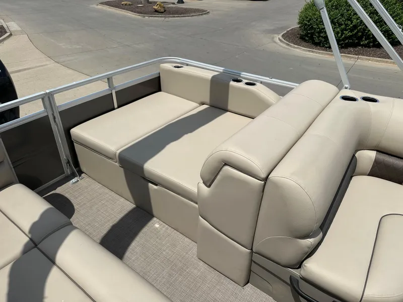 Slide: The Image of 2025 Sun Tracker Party Barge 22 RF DLX with beige seating and cup holders. - 6