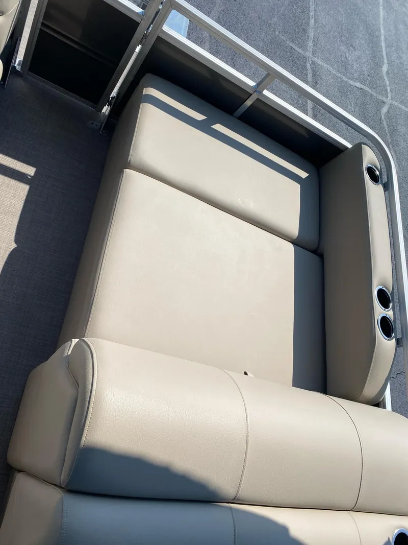 Slide: The Image of 2025 Sun Tracker Party Barge 22 RF DLX with beige seating and cup holders. - 14