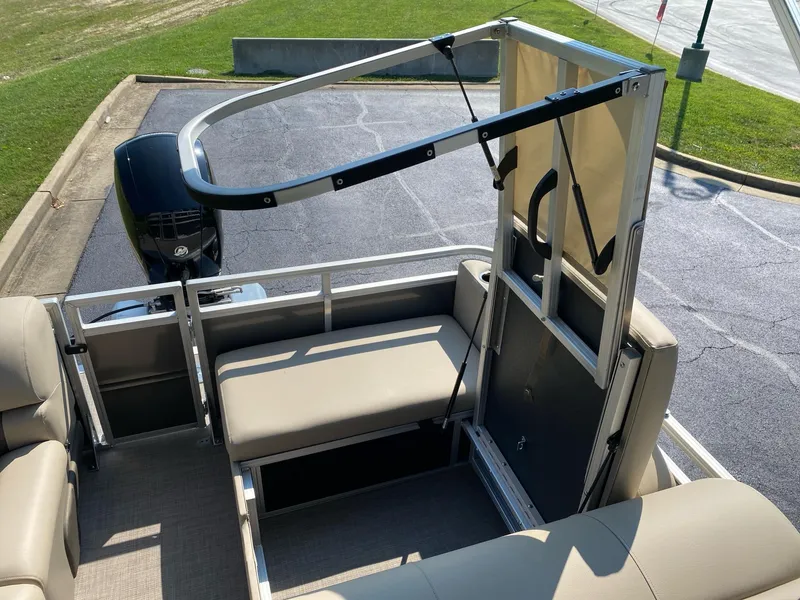 Slide: The Image of 2025 Sun Tracker Party Barge 22 RF DLX interior with seating and motor view. - 15