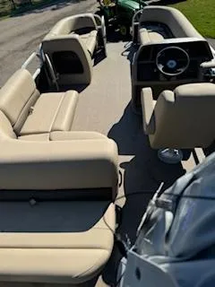 Slide: The Image of 2025 Sun Tracker Party Barge 18 DLX with beige seating and steering console. - 5