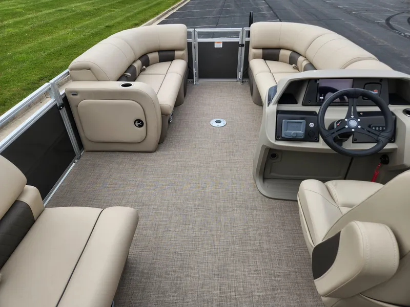 Slide: The Image of 2025 Sun Tracker Party Barge 22 RF DLX interior with beige seating and modern helm. - 5